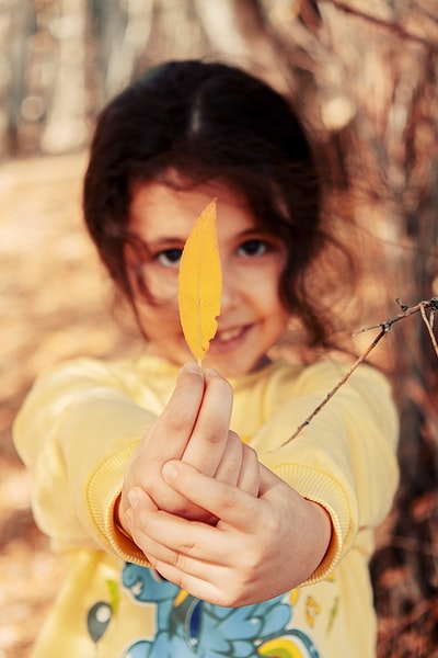 Women who dress in yellow sweater with yellow leaves
